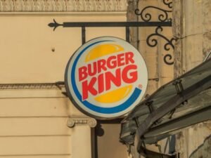 Burger King sign displayed on a historic street in Wrocław, Poland.
