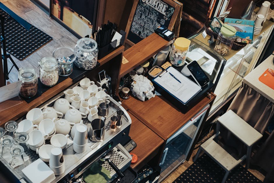 Overhead view of a café in Krasnodar, showcasing coffee cups, cash register, and cozy atmosphere.