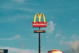 Bright McDonald's sign under clear sky, featuring the 'Automac' label.